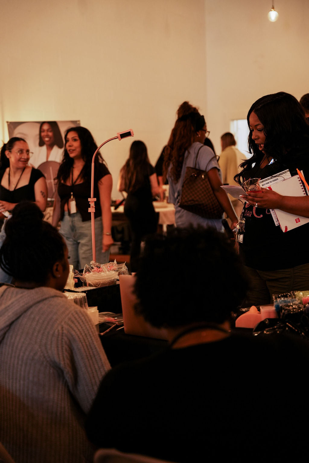 Group of people at a social event with drinks and conversation.